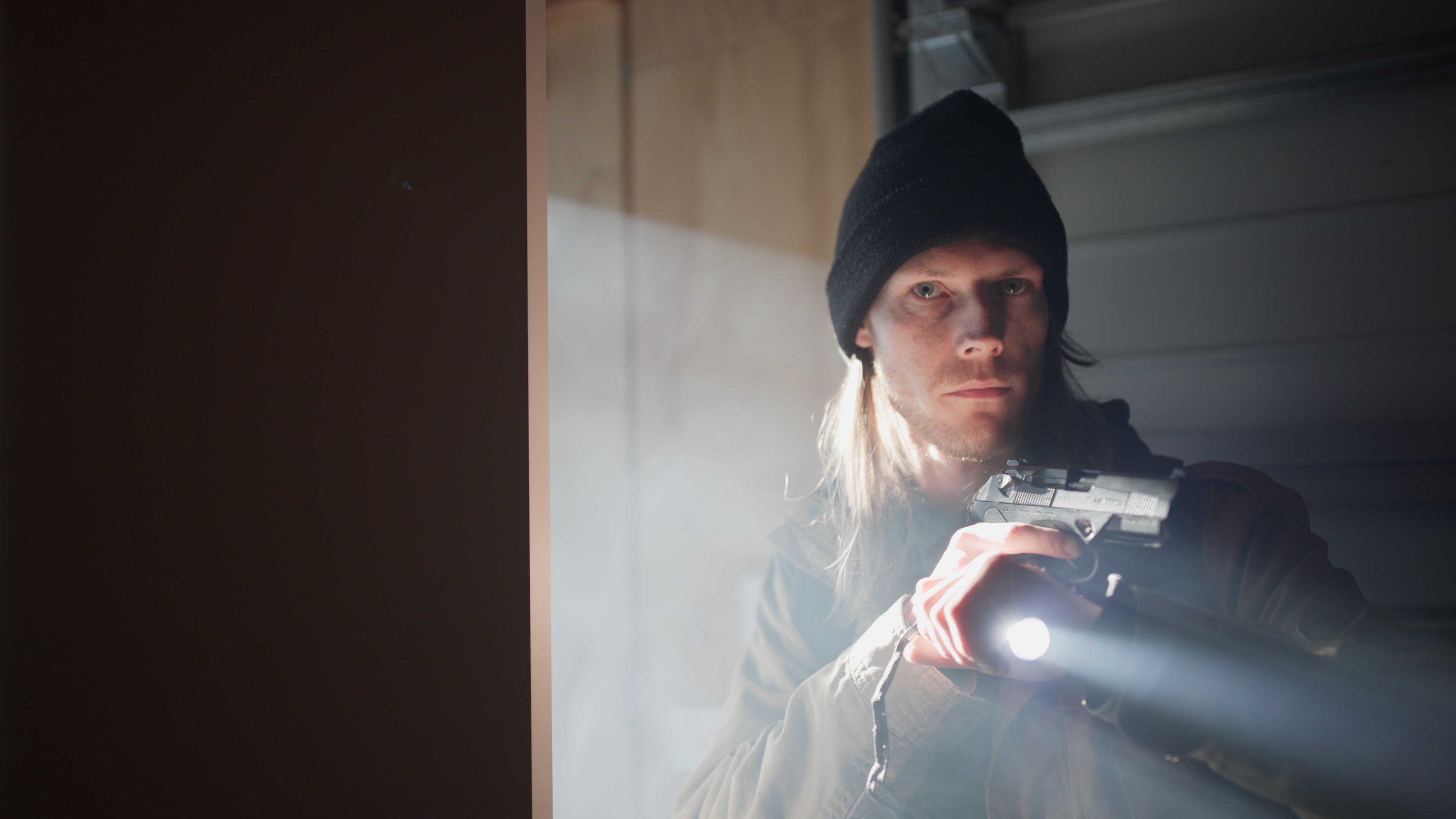 Tyler entering shed with weapon drawn